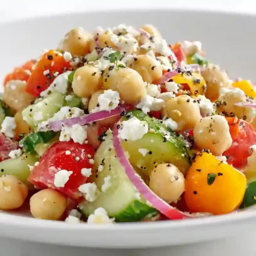 A rustic bowl of creamy chicken enchilada soup, loaded with tender shredded chicken, black beans, corn, and topped with melted cheese, fresh cilantro, and a dollop of sour cream