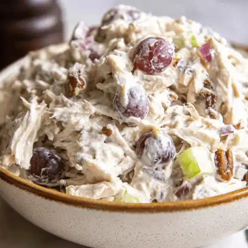 Close-up of a creamy chicken salad with red grapes, pecans, and celery, perfect for a quick 15-Minute Chicken Salad Sandwich Recipe.