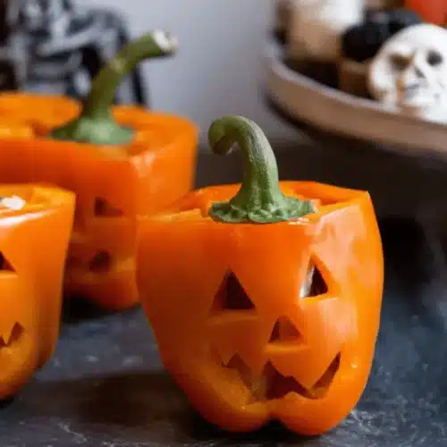 Festive Jack-O’-Lantern Stuffed Peppers with Halloween cupcakes and and treats.