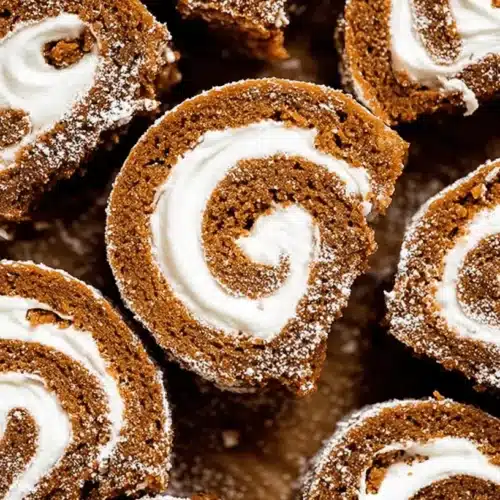 Close-up of delectable pumpkin roll slices with creamy filling, inspiring new pumpkin dessert recipes.